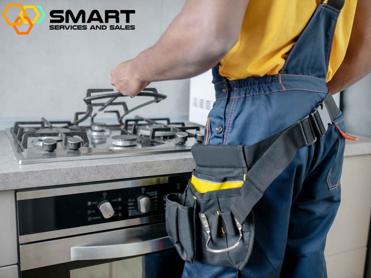 A technician working on a stove repair