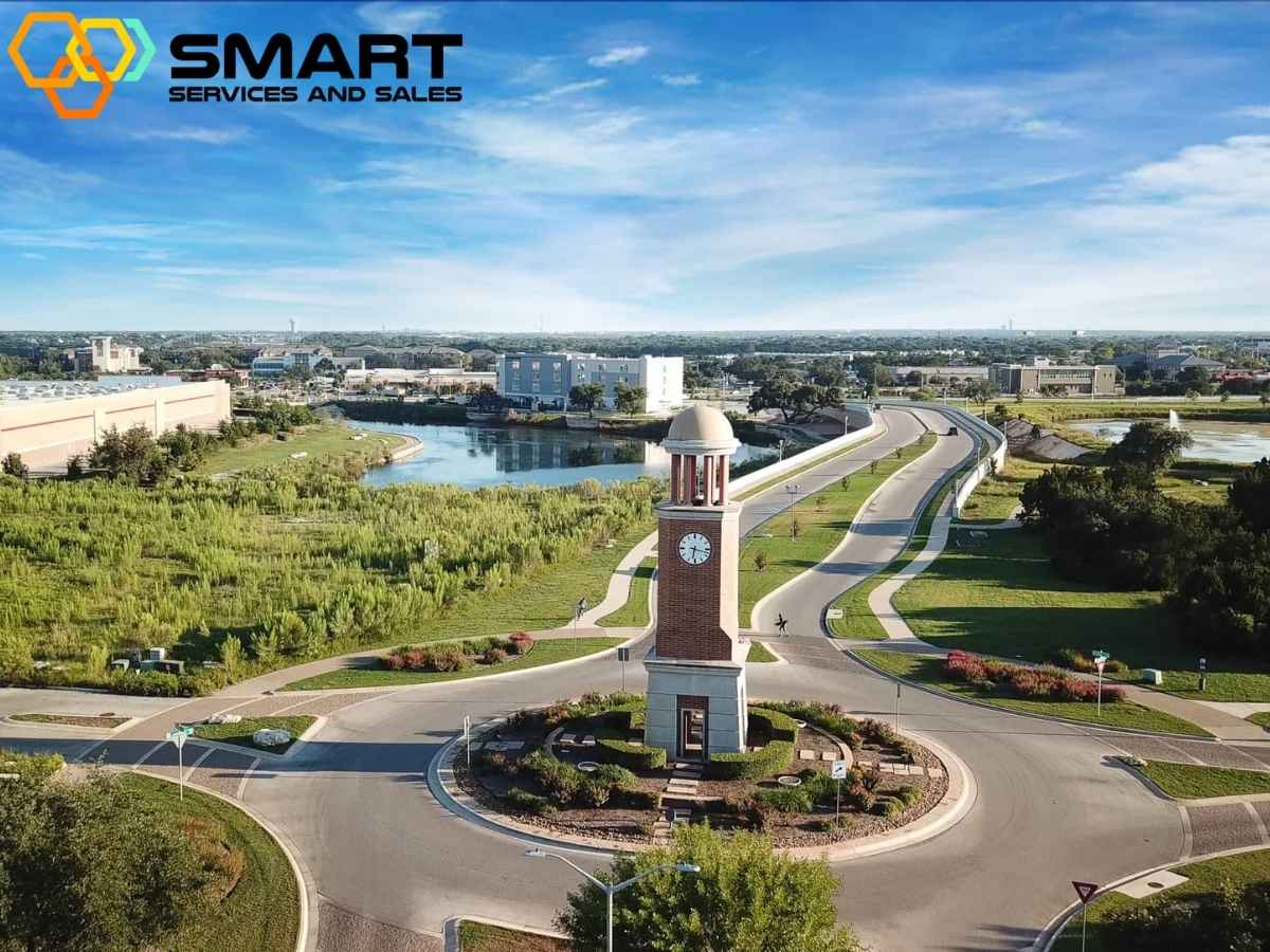 Aerial view of Cedar Park Texas with the prominent clock tower and surrounding landscape