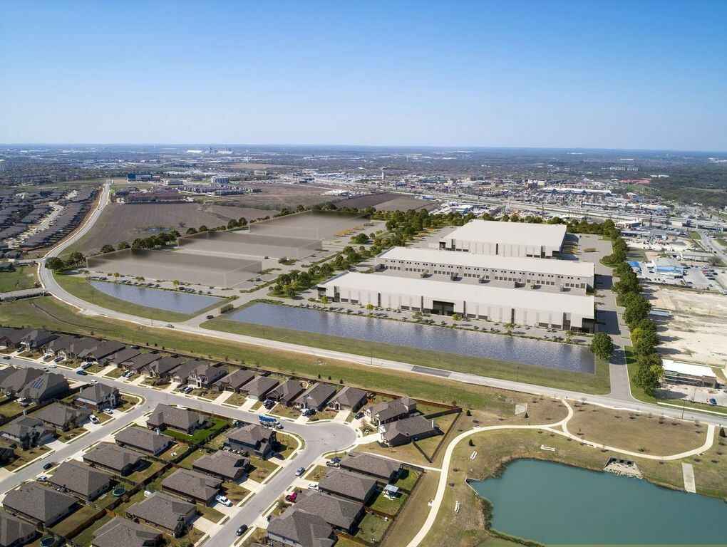 An aerial view of a new development in Buda Texas featuring a mix of commercial and residential buildings