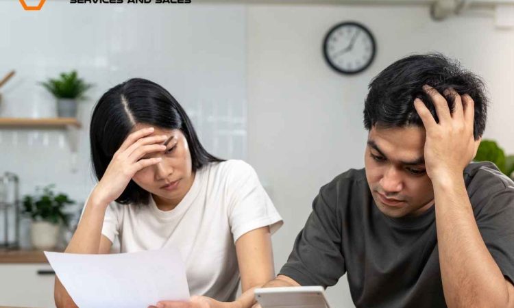 Common appliance repair issues Picture of a couple holding paper with one hand and having oter hand on heads seems worry